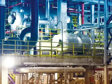 Fertilizer plant process area with blue steelwork, vessels and pipe racks