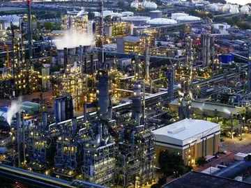 Chemical complex at dusk seen from above, its process units lit across the site